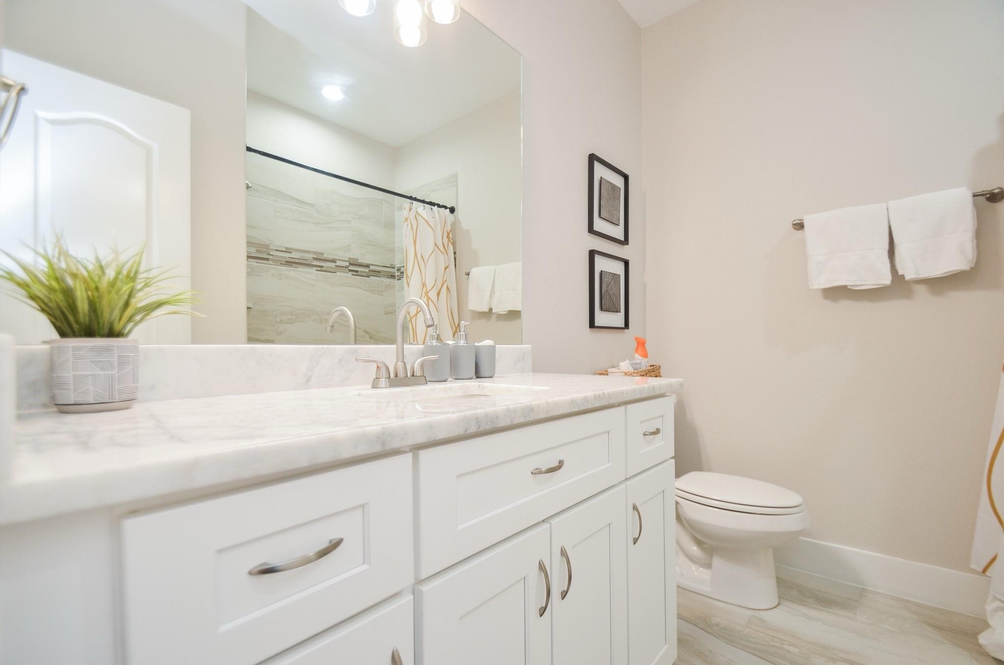 4511 Reed Road, Unit A Houston, TX 77051 - Photo 26 of 34 a bathroom with a granite countertop toilet sink and mirror