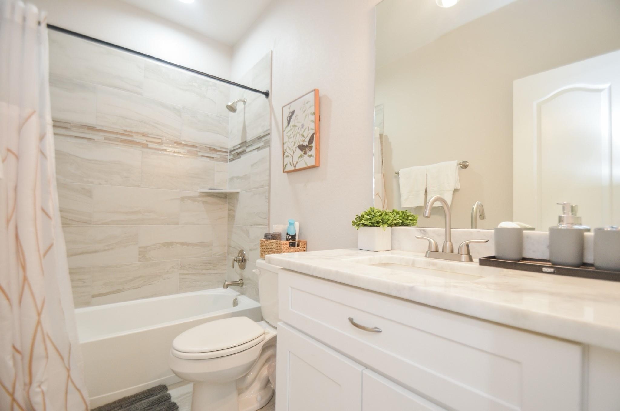 4511 Reed Road, Unit A Houston, TX 77051 - Photo 31 of 34 a bathroom with a sink a toilet and a bathtub
