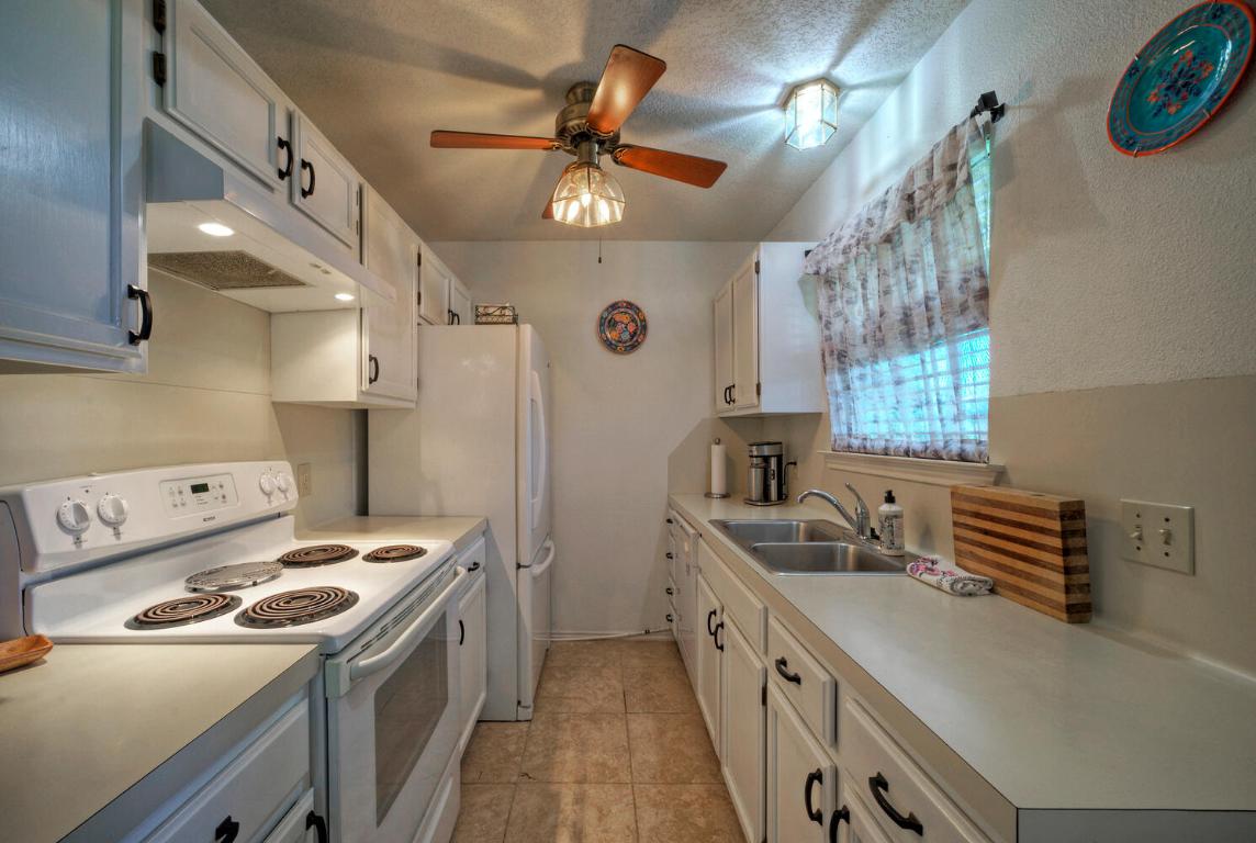 906-828 Water Street Manor, TX 78653 - Photo 6 of 40 a kitchen that has a sink a stove and a dishwasher
