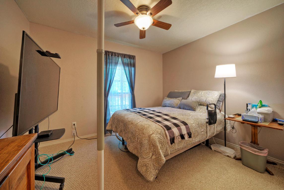 906-828 Water Street Manor, TX 78653 - Photo 8 of 40 a bed room with a bed and a chandelier