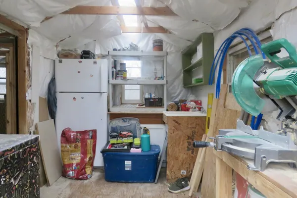 a living room with furniture a flat screen tv and a toilet
