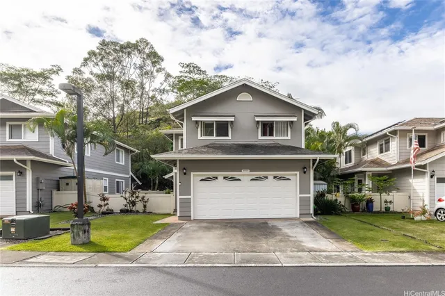 a front view of a house with a yard and garage