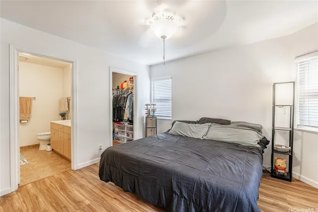 a bedroom with a large bed and a chandelier
