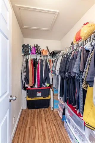 a view of walk in closet with clothes
