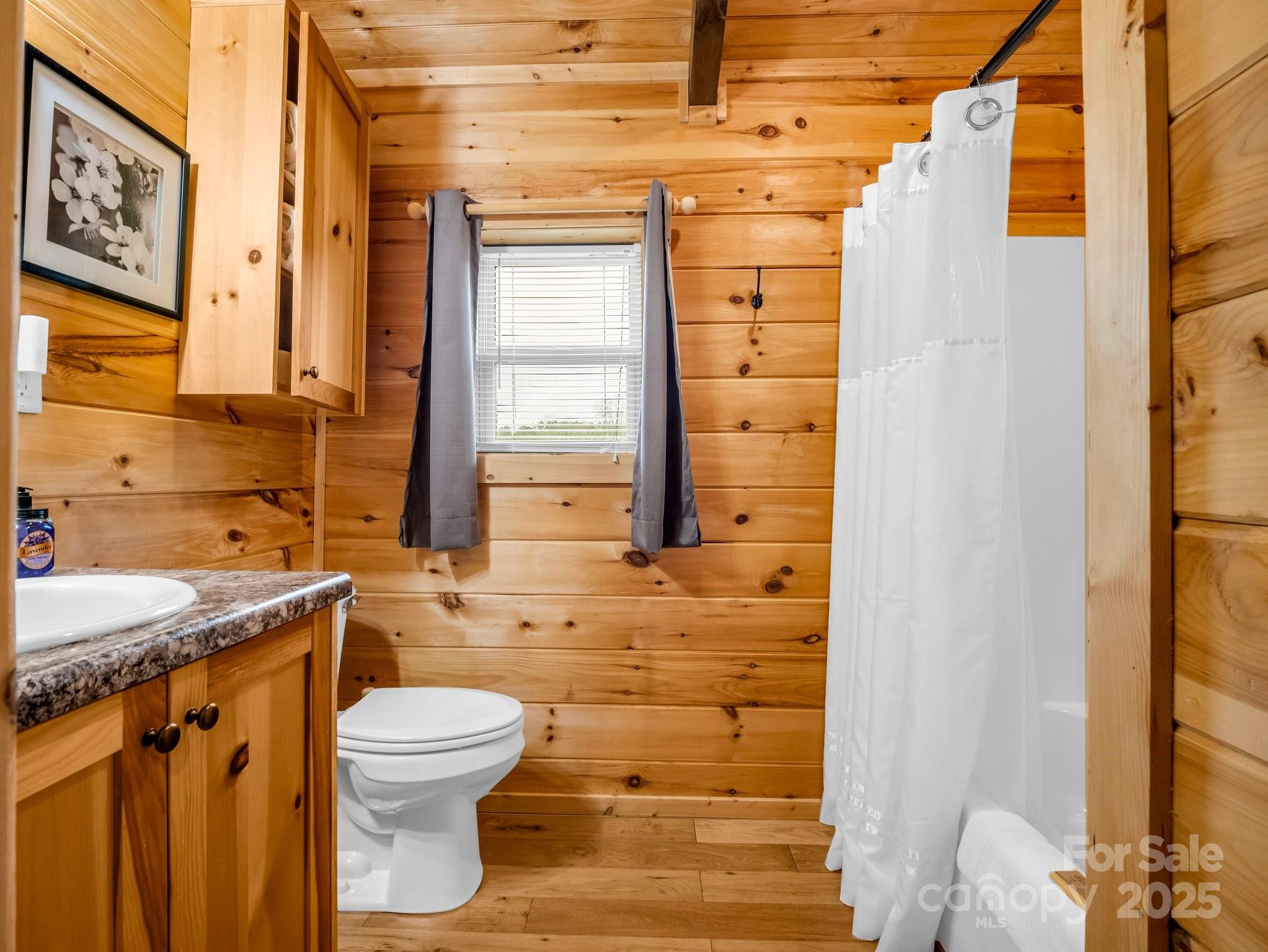 1217 Moore Road, Unit 70 80 & 90 Tryon, NC 28782 - Photo 22 of 42 a bathroom with a granite countertop sink toilet and shower