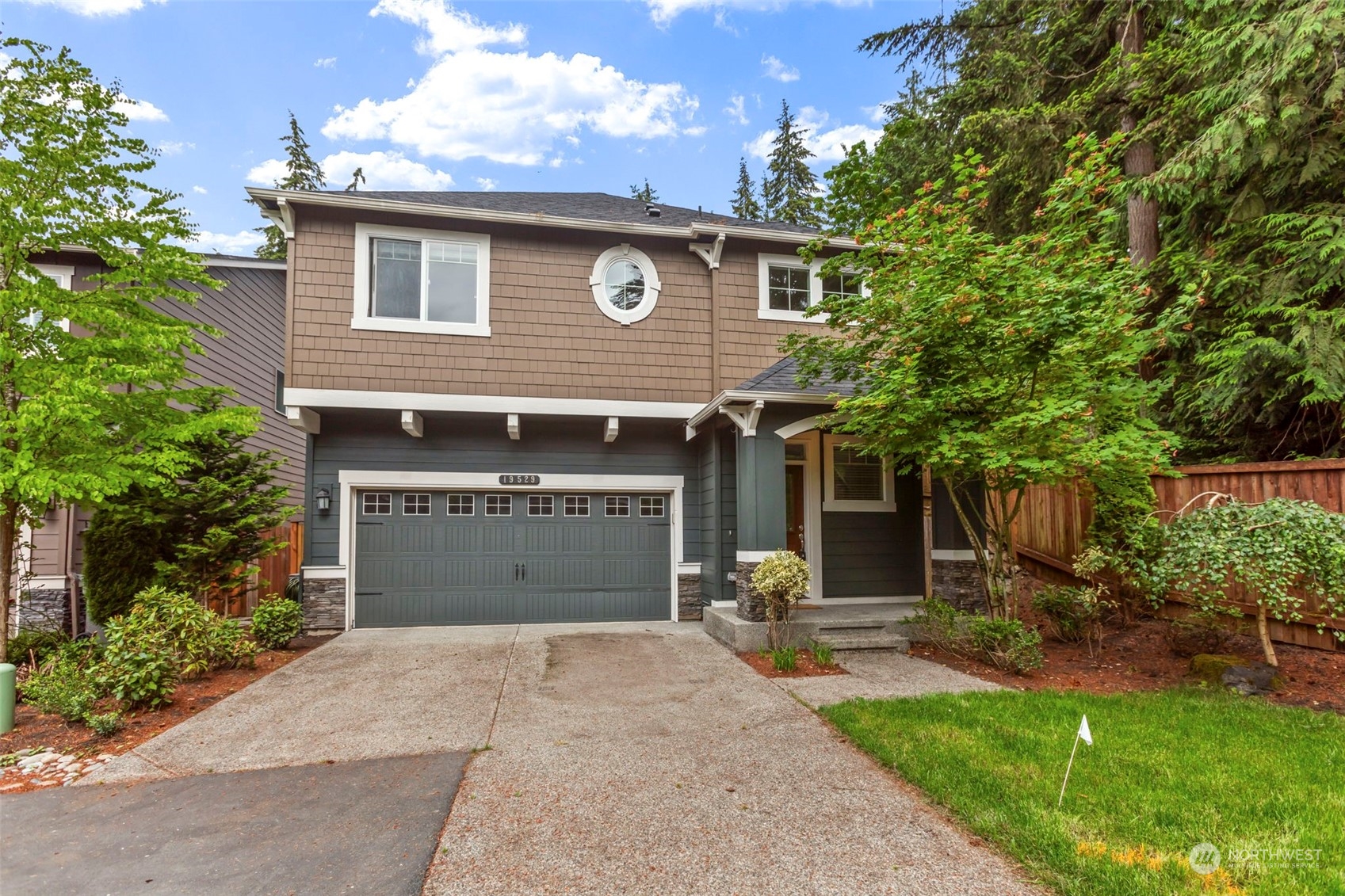 19529 34th Drive Southeast Bothell, WA 98012 - Photo 1 of 38 a front view of a house with a yard and garage