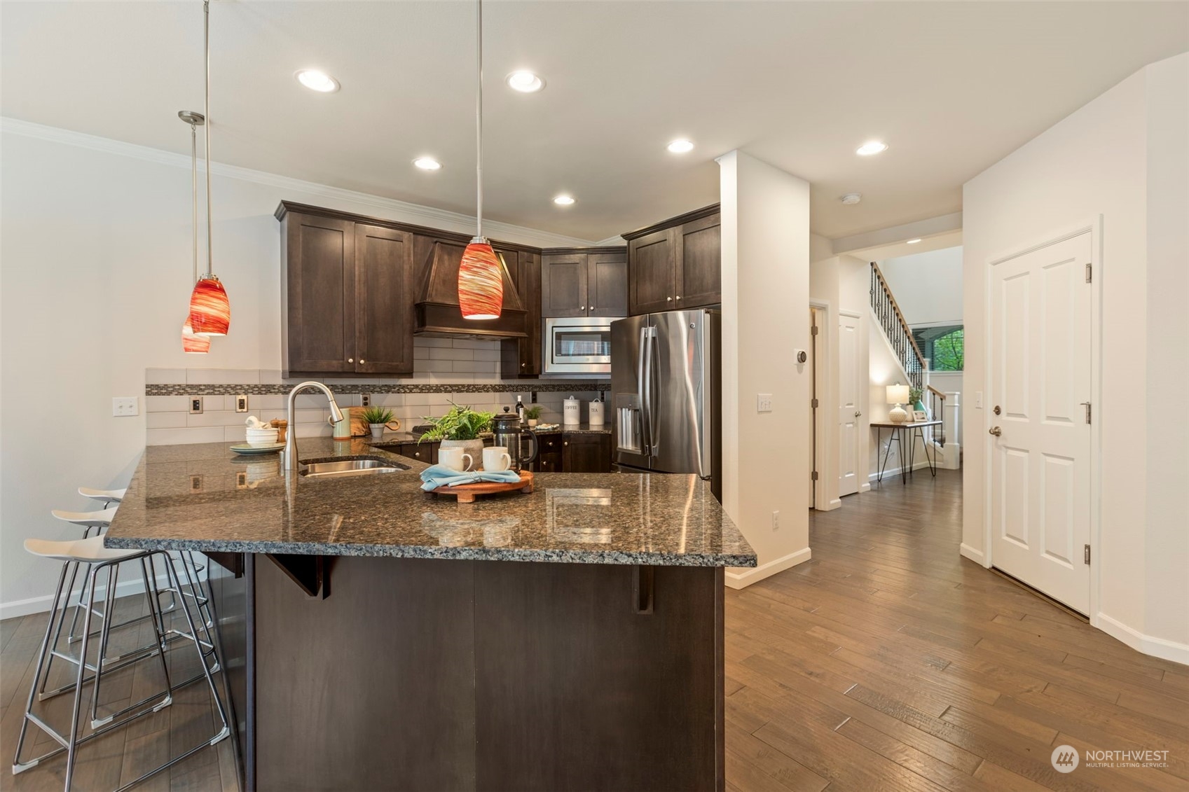 19529 34th Drive Southeast Bothell, WA 98012 - Photo 9 of 38 a kitchen with stainless steel appliances granite countertop a sink refrigerator and cabinets