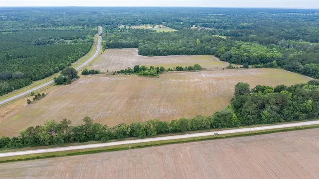 an aerial view of a house with a yard and lake view