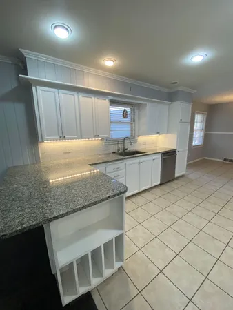a kitchen with stainless steel appliances granite countertop a sink and a granite counter tops