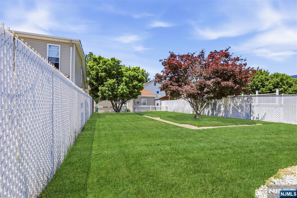 332 Riverside Avenue Lyndhurst, NJ 07071 - Photo 6 of 31 a front view of a house with a yard and a garage