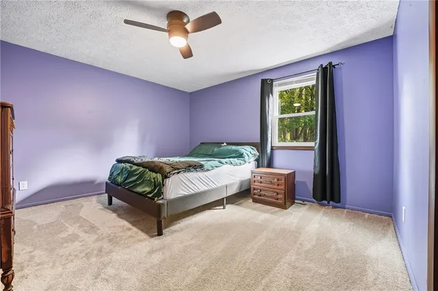 a bedroom with a bed and a couch