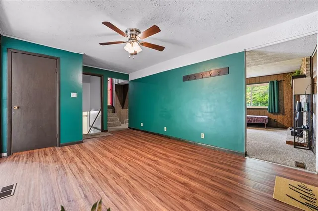 a view of a livingroom with a hall and wooden floor