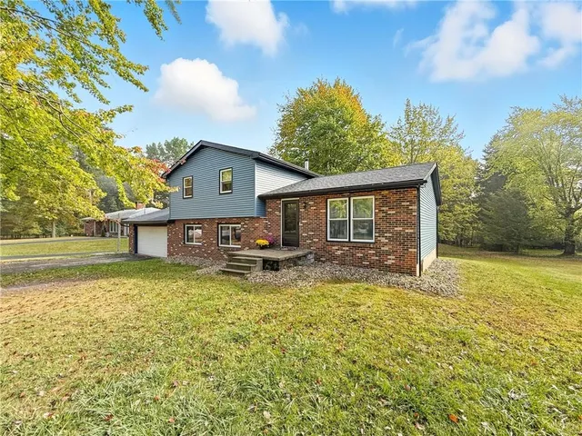 a front view of a house with swimming pool and porch with furniture