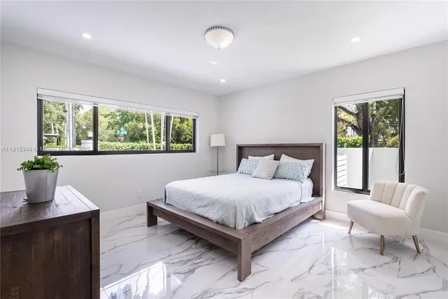 a bedroom with a large bed and a window