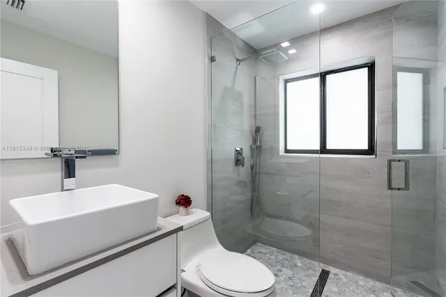 a bathroom with a sink toilet and shower