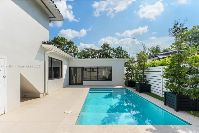 a view of house with backyard and garden
