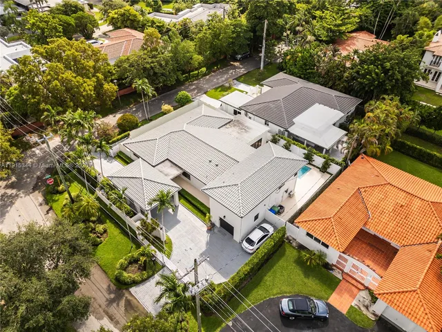 an aerial view of a house with a yard