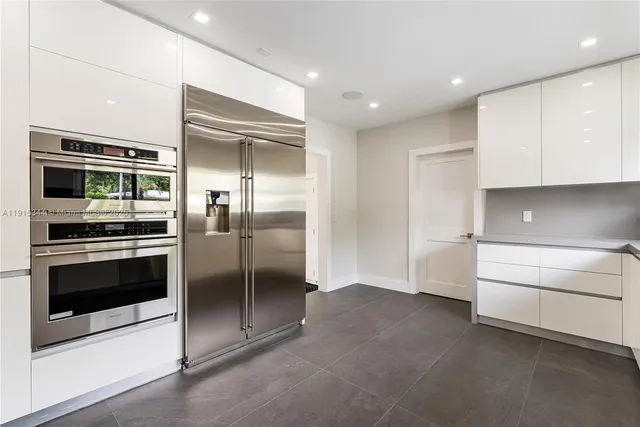 a kitchen with a refrigerator and an oven