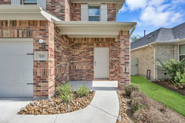 a front view of a house with a garden