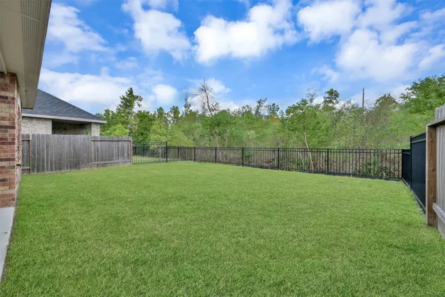 a view of a yard and front view of a house