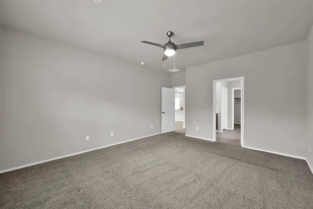 an empty room with fan and a ceiling fan