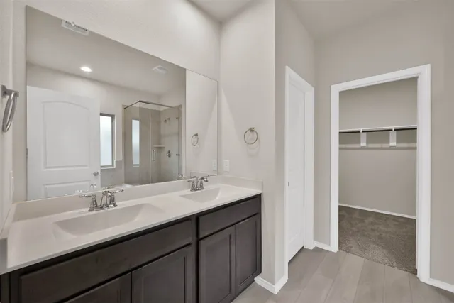 a bathroom with a sink double vanity and a mirror
