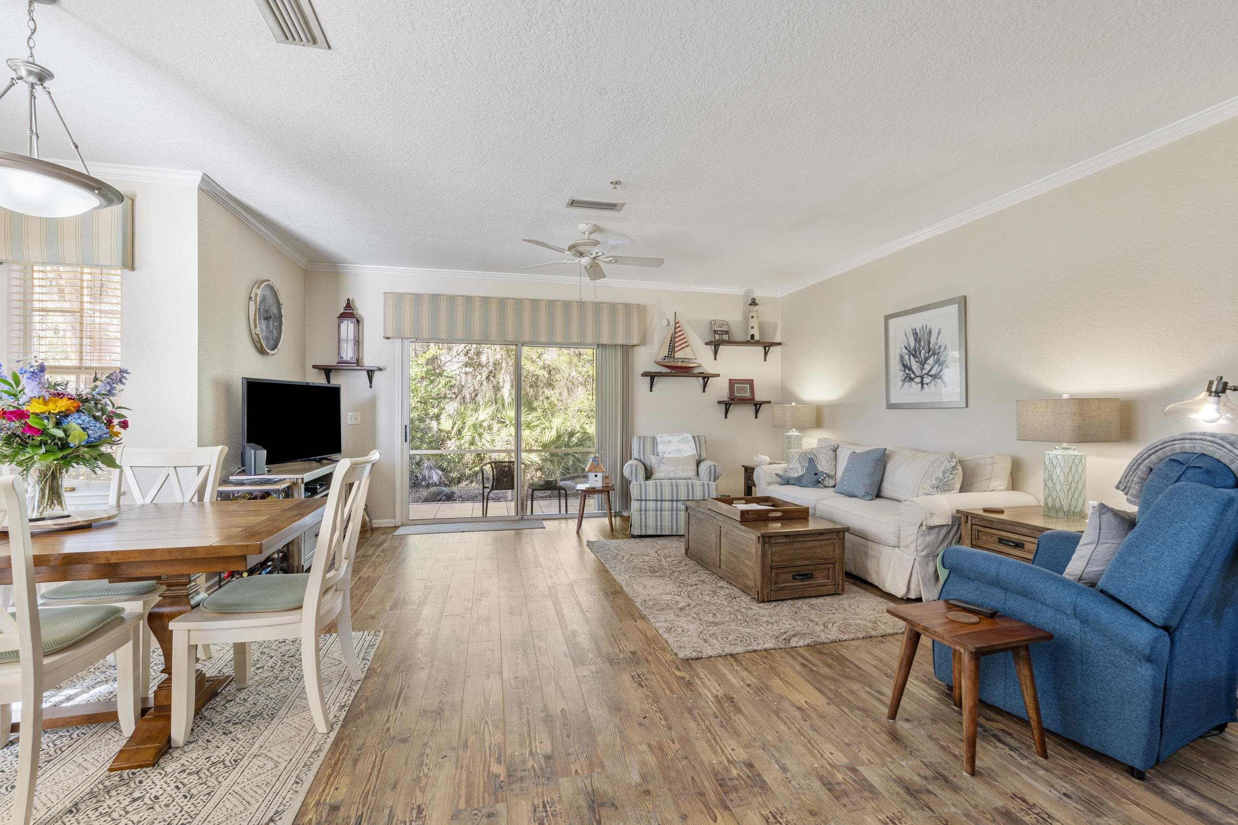 110 Magnolia Crossing Point, Unit 1901 St. Augustine, FL 32086 - Photo 11 of 38 Living area featuring wood-type flooring, a textured ceiling, a ceiling fan, and ornamental molding