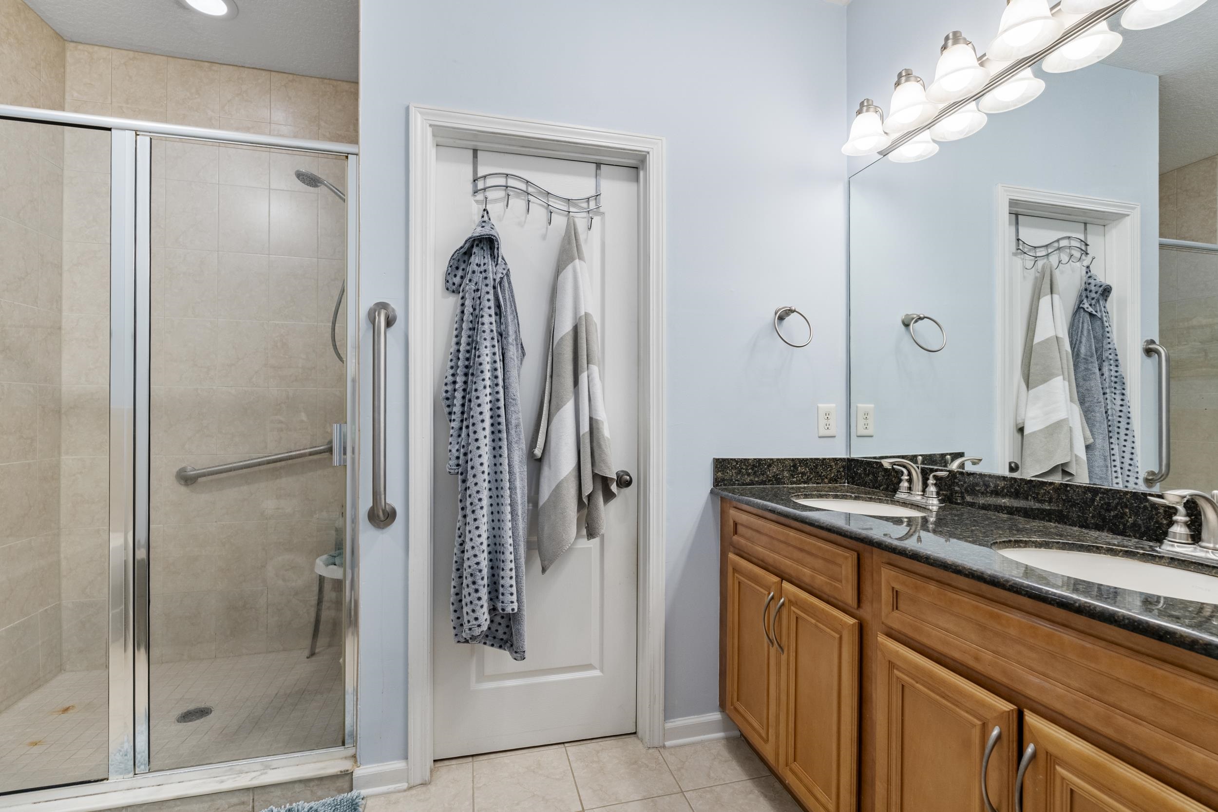 110 Magnolia Crossing Point, Unit 1901 St. Augustine, FL 32086 - Photo 13 of 38 Bathroom with a stall shower, double vanity, and light tile patterned flooring