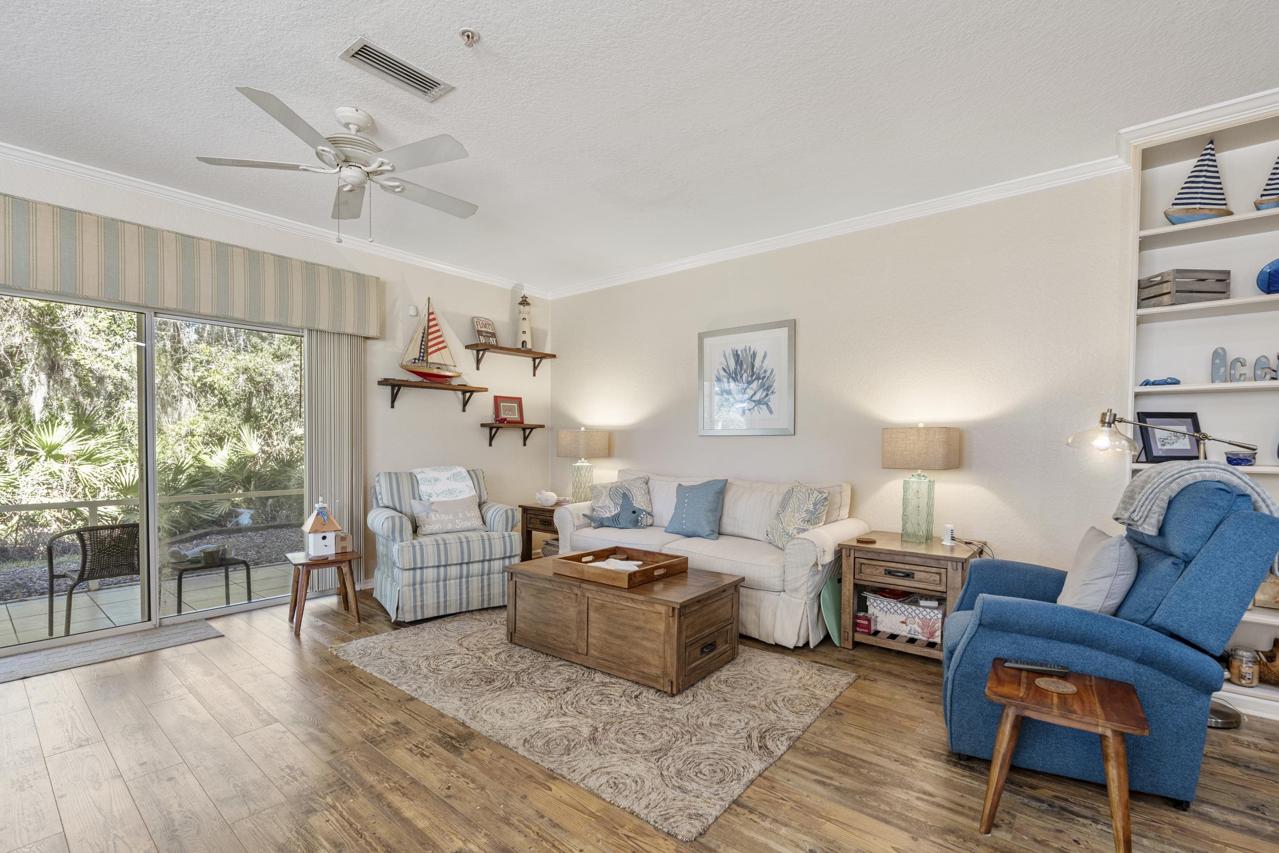 110 Magnolia Crossing Point, Unit 1901 St. Augustine, FL 32086 - Photo 14 of 38 Living room featuring wood finished floors, ceiling fan, ornamental molding, and a textured ceiling
