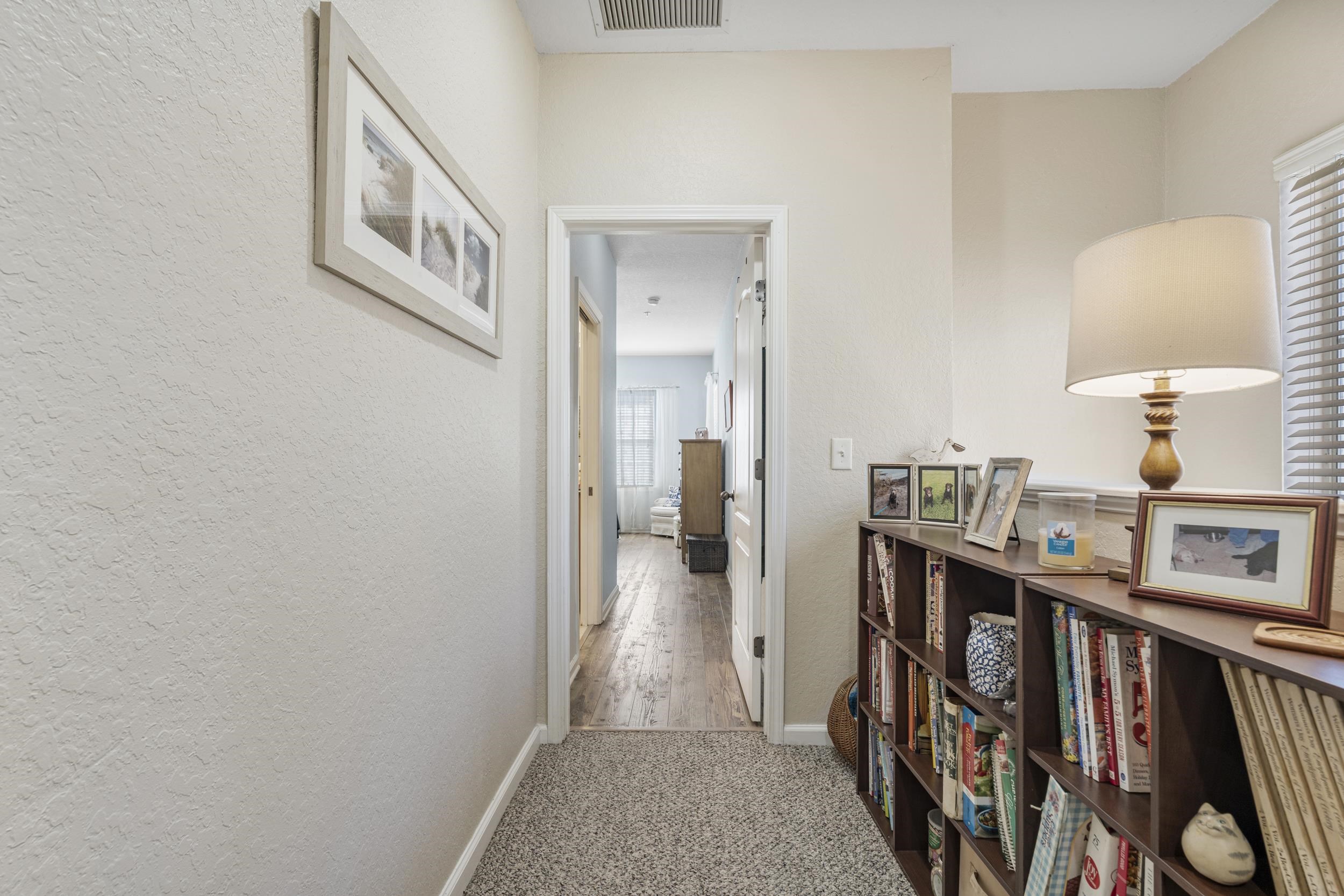 110 Magnolia Crossing Point, Unit 1901 St. Augustine, FL 32086 - Photo 17 of 38 Hall featuring light colored carpet and a textured wall