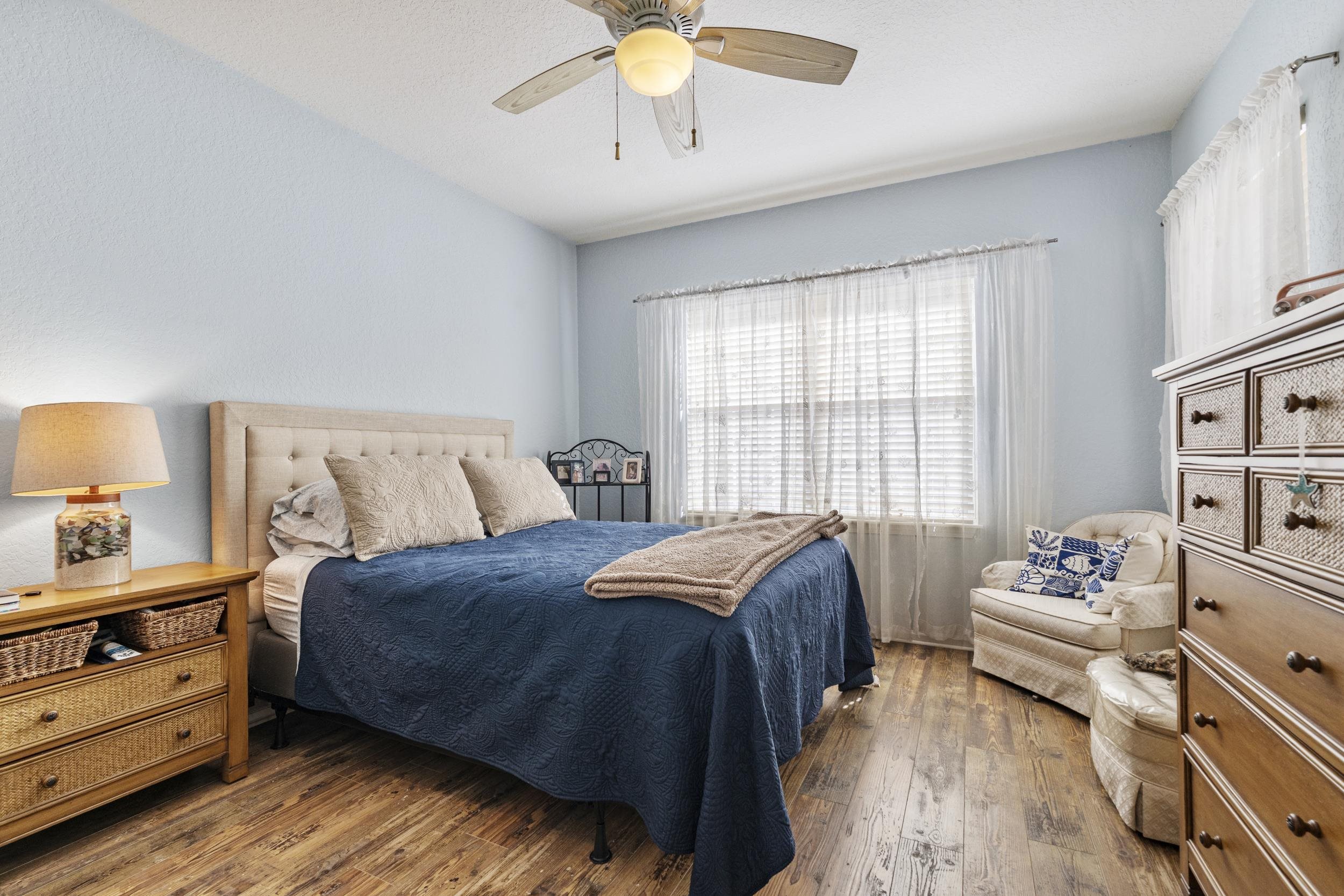 110 Magnolia Crossing Point, Unit 1901 St. Augustine, FL 32086 - Photo 18 of 38 Bedroom with dark wood finished floors and ceiling fan