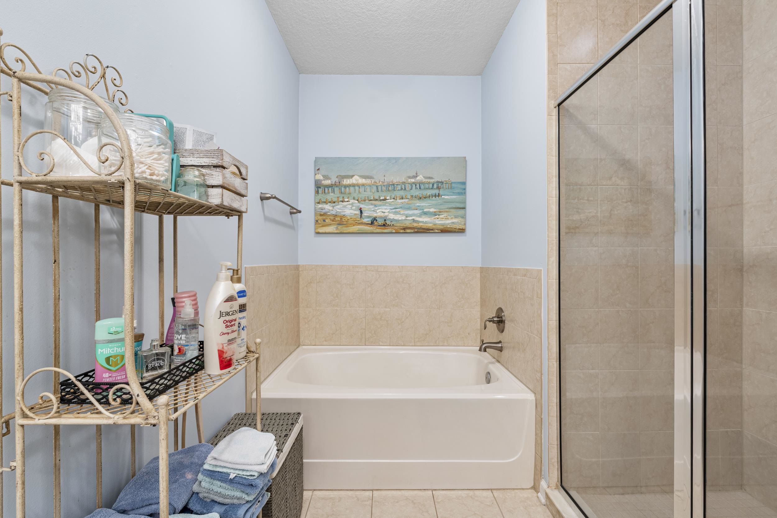110 Magnolia Crossing Point, Unit 1901 St. Augustine, FL 32086 - Photo 19 of 38 Bathroom featuring a garden tub, a textured ceiling, a shower stall, and tile patterned flooring