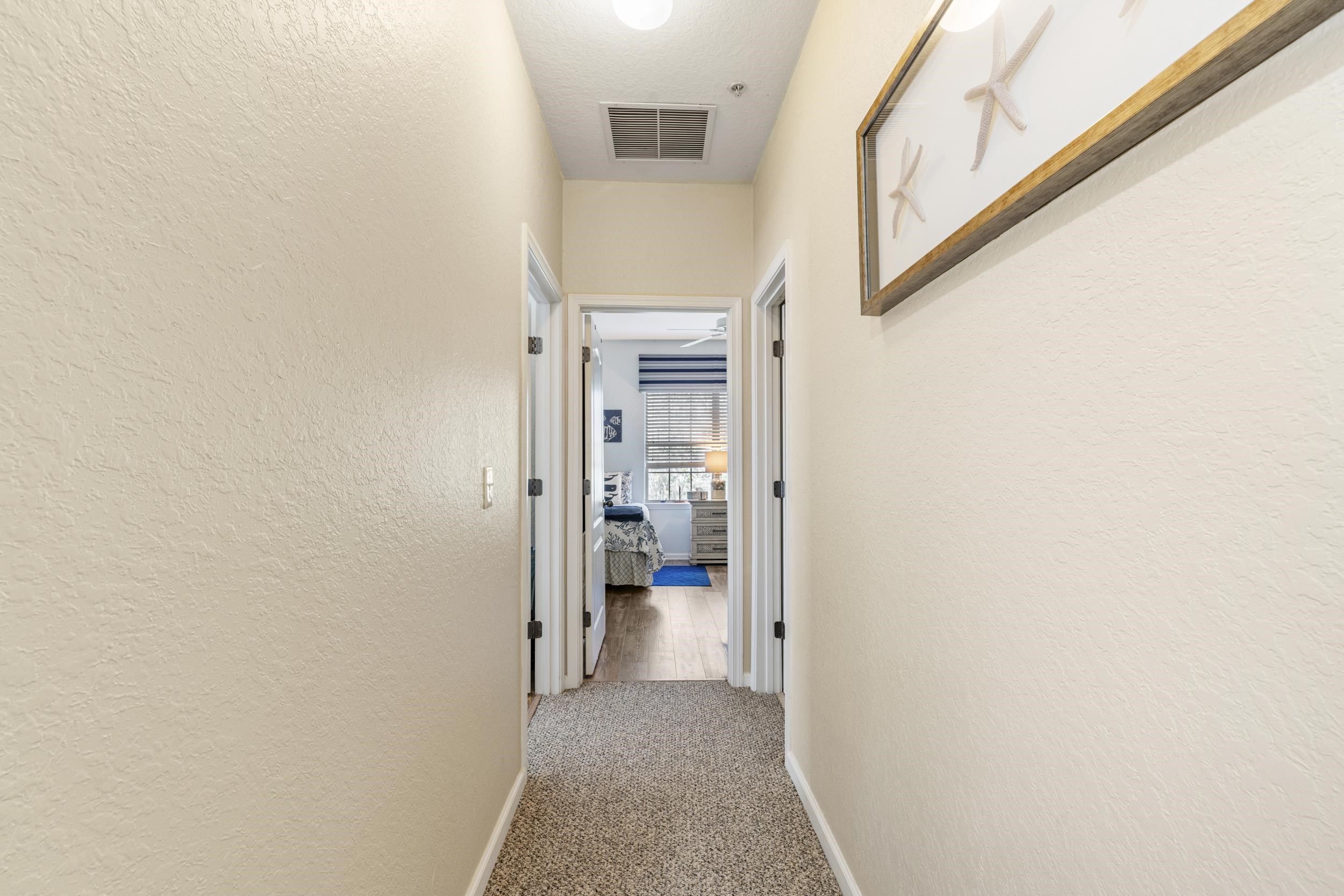 110 Magnolia Crossing Point, Unit 1901 St. Augustine, FL 32086 - Photo 20 of 38 Corridor with light colored carpet and a textured wall
