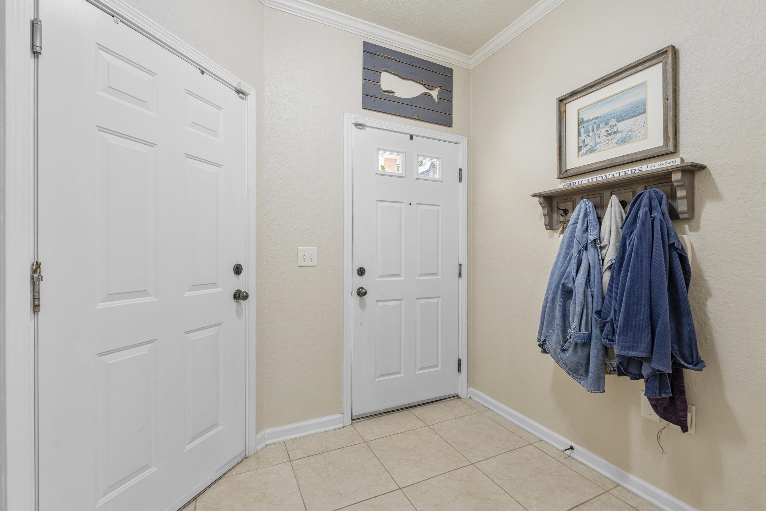 110 Magnolia Crossing Point, Unit 1901 St. Augustine, FL 32086 - Photo 6 of 38 Entryway featuring crown molding and light tile patterned flooring