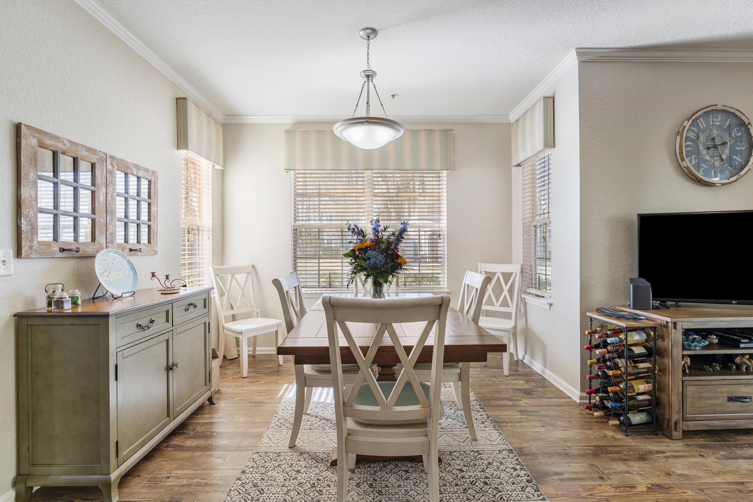 110 Magnolia Crossing Point, Unit 1901 St. Augustine, FL 32086 - Photo 9 of 38 Dining space with dark wood-type flooring, plenty of natural light, and crown molding
