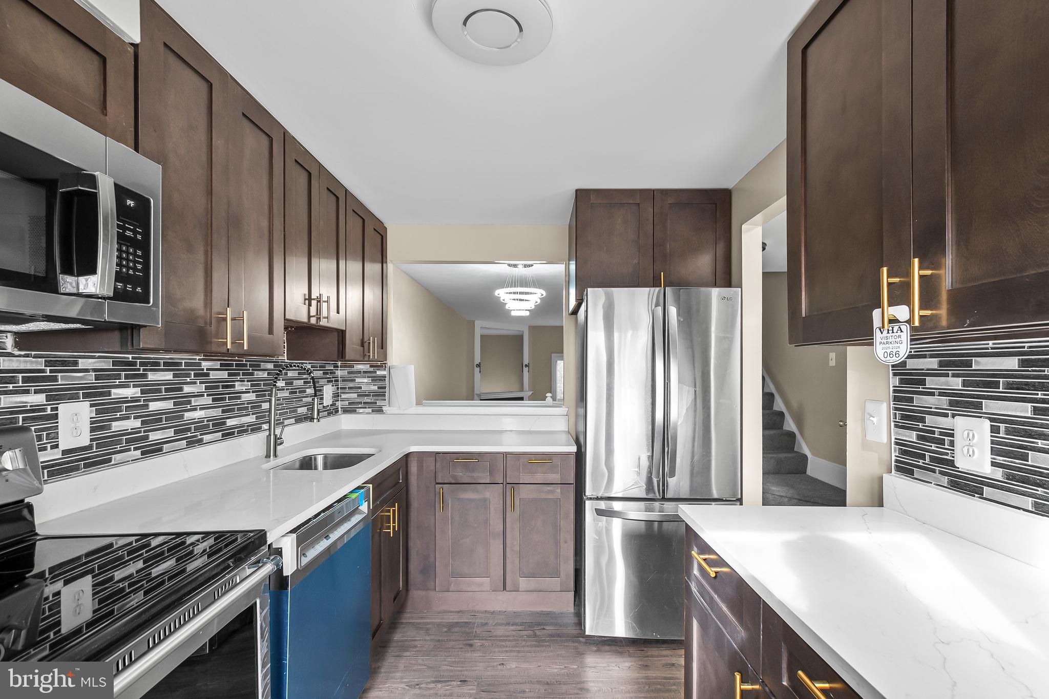 a kitchen with a sink stainless steel appliances and cabinets