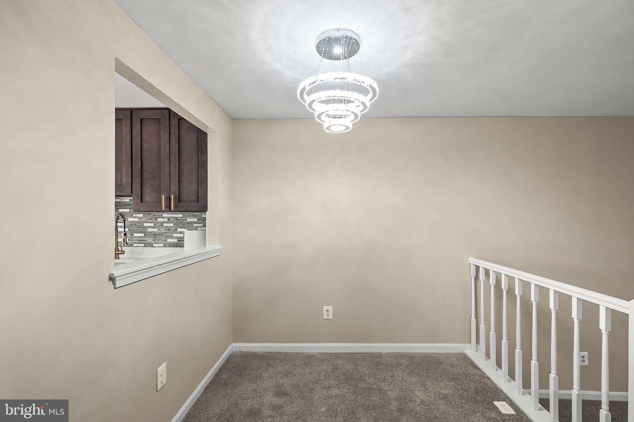 6185 Little Valley Way Alexandria, VA 22310 - Photo 11 of 44 an empty room with a chandelier