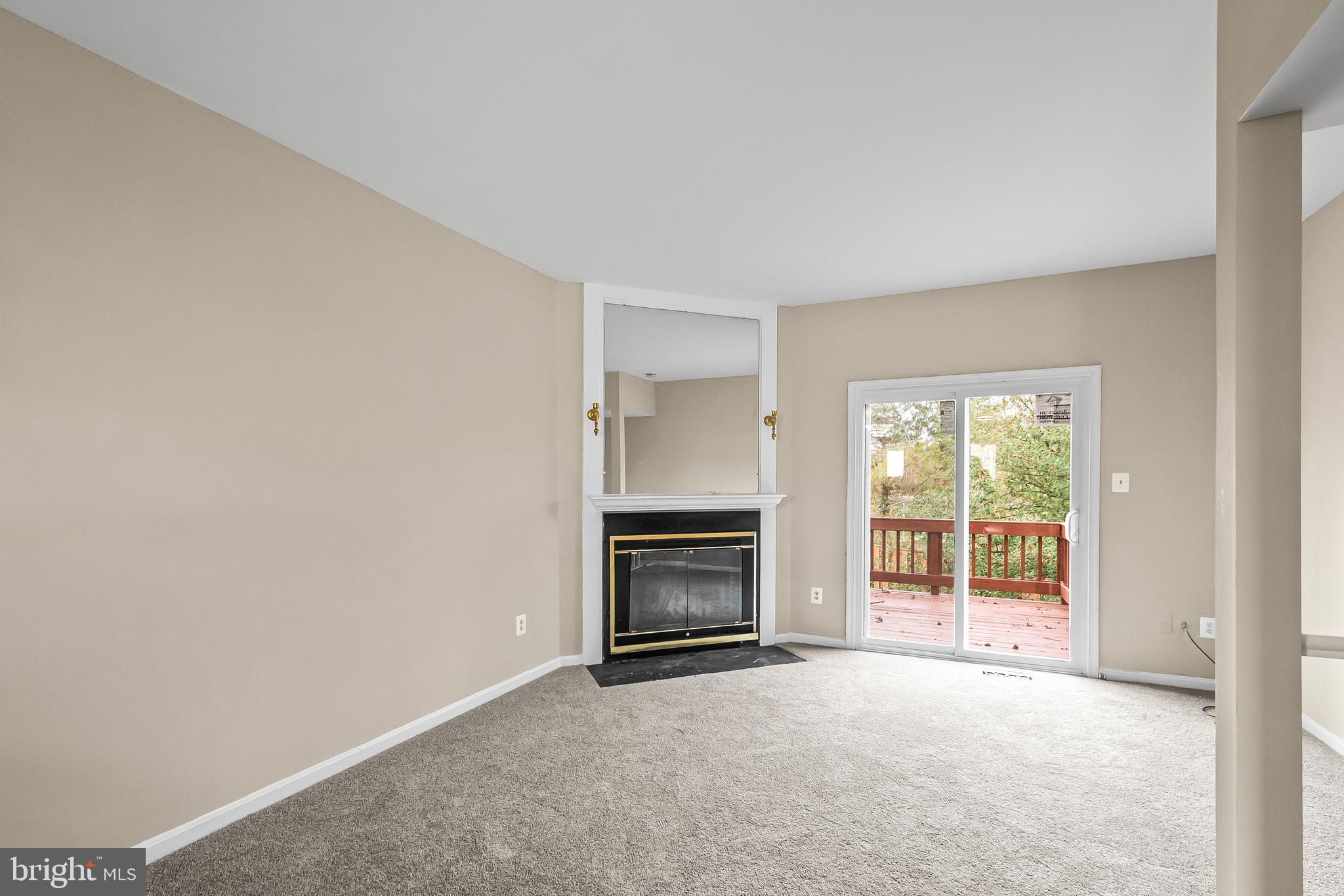 6185 Little Valley Way Alexandria, VA 22310 - Photo 12 of 44 a view of an empty room with a fireplace and a window