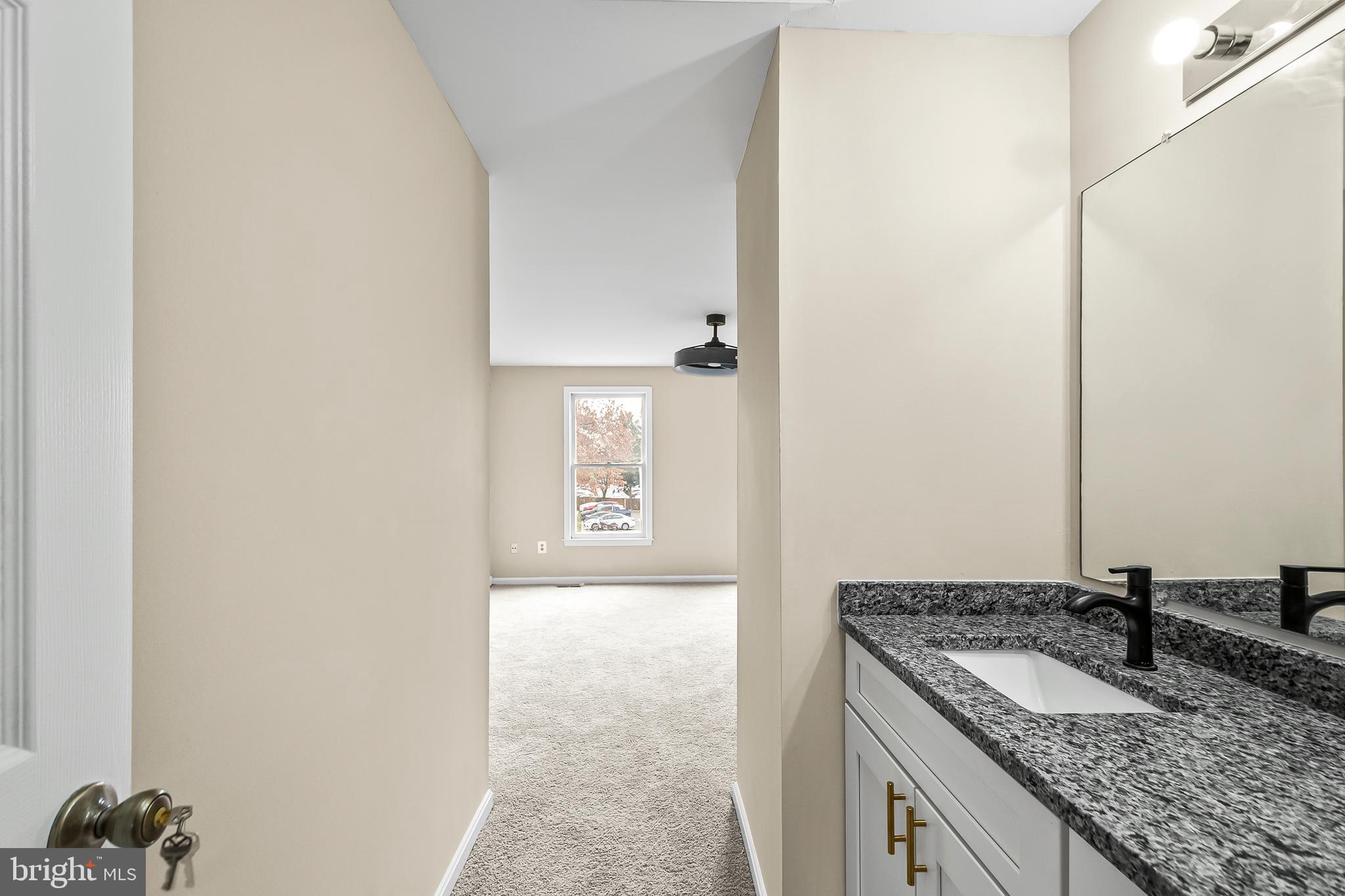 6185 Little Valley Way Alexandria, VA 22310 - Photo 25 of 44 a bathroom with a granite countertop sink and a mirror