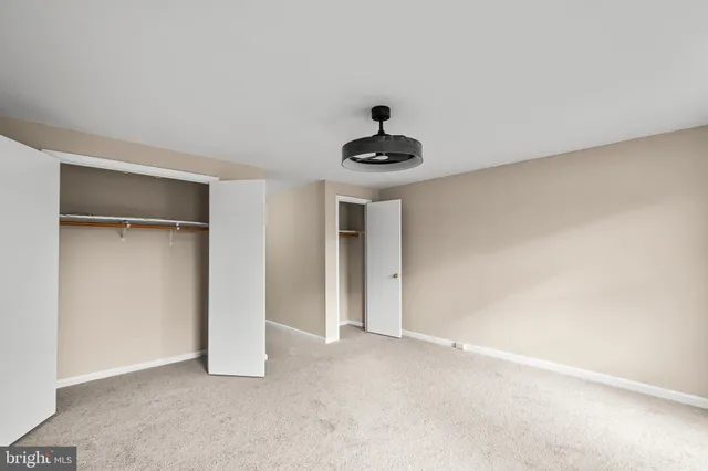 a view of an empty room with a fan