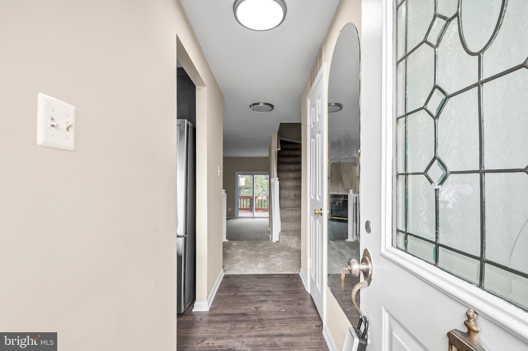 6185 Little Valley Way Alexandria, VA 22310 - Photo 42 of 44 a view of a hallway with wooden floor and door
