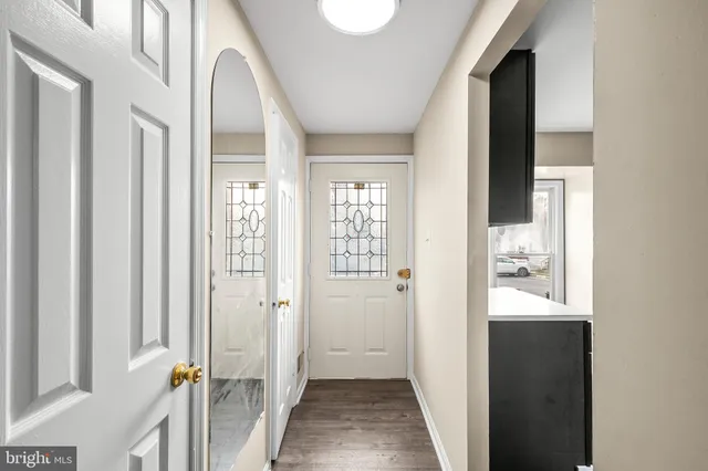 a view of a hallway with a white walls and stairs