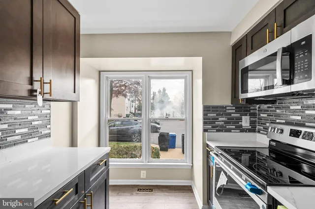 a kitchen with a stove and a refrigerator