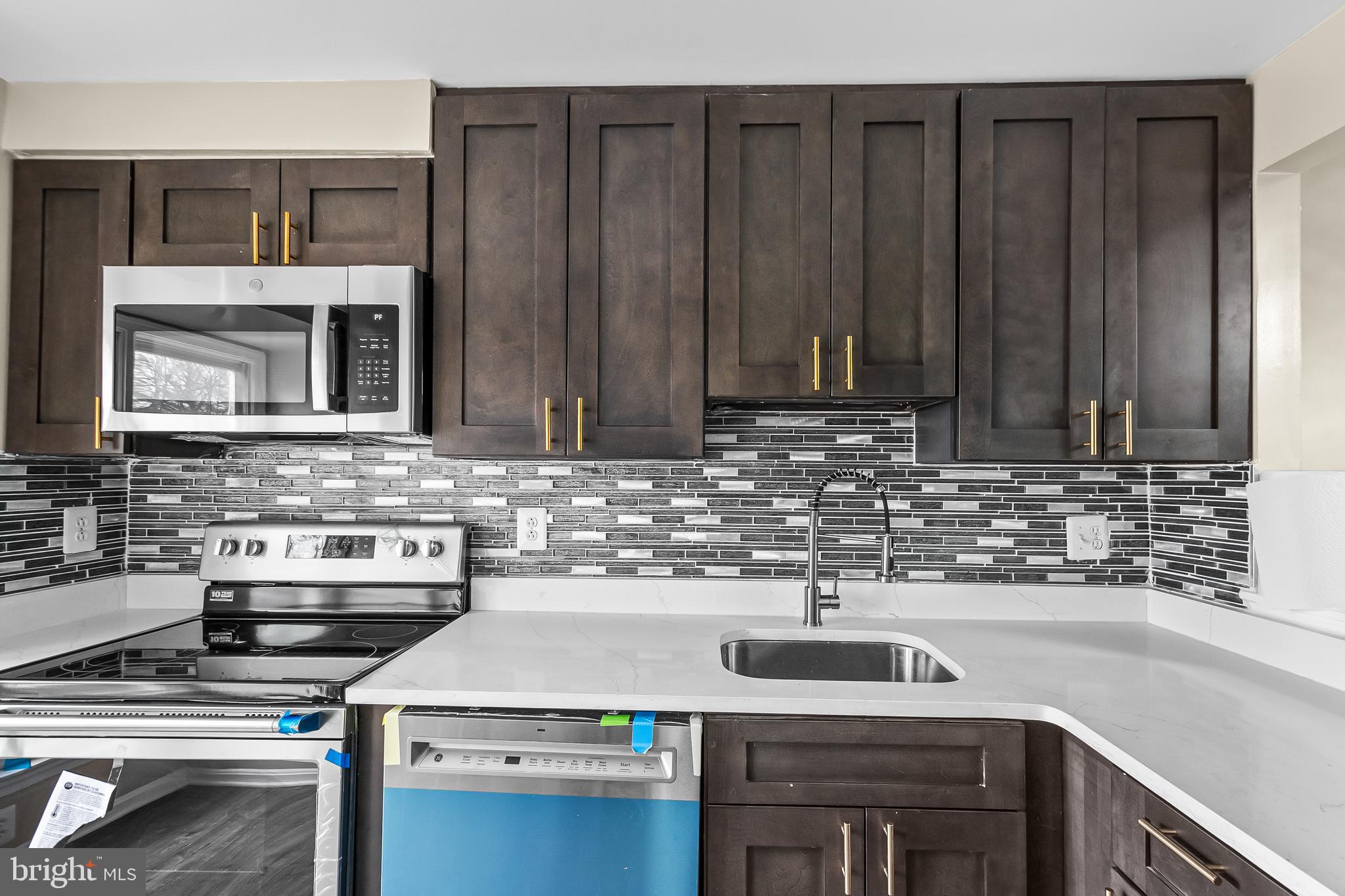 6185 Little Valley Way Alexandria, VA 22310 - Photo 8 of 44 a kitchen with stainless steel appliances a stove and a sink