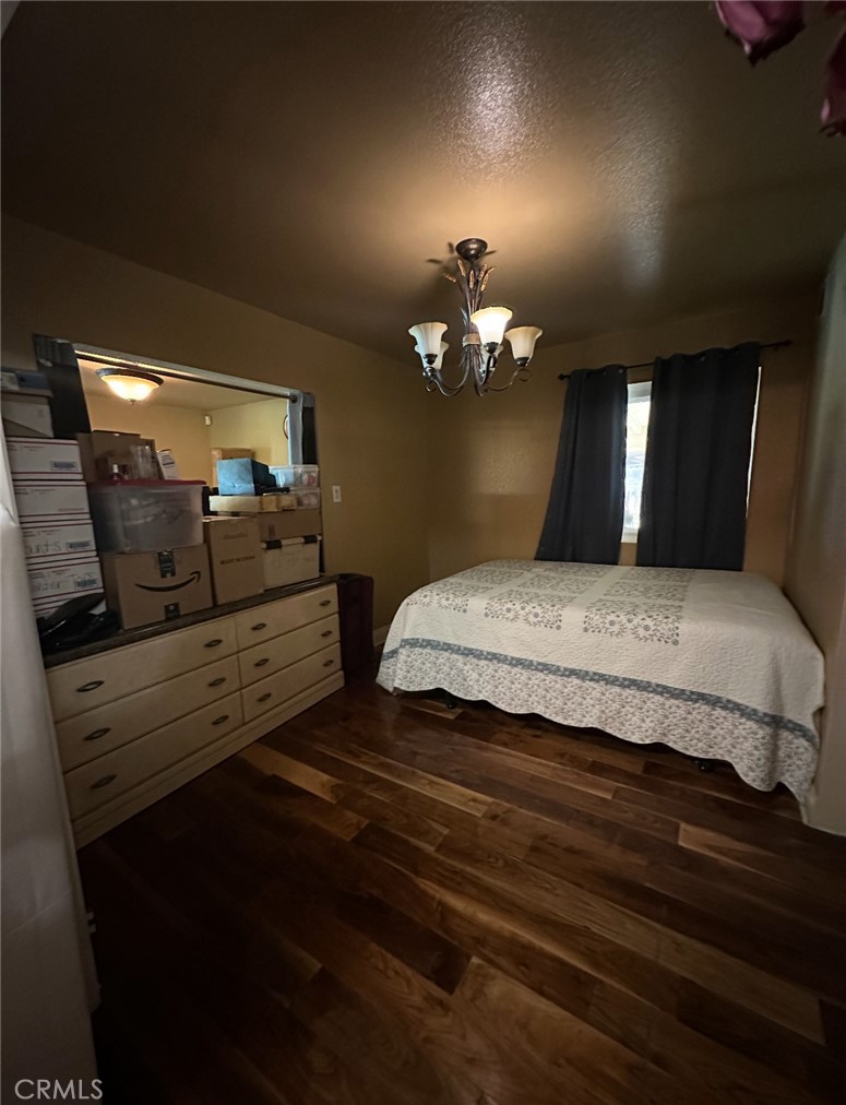 1510 Karon Street Redlands, CA 92374 - Photo 13 of 14 a bedroom with a bed and chandelier