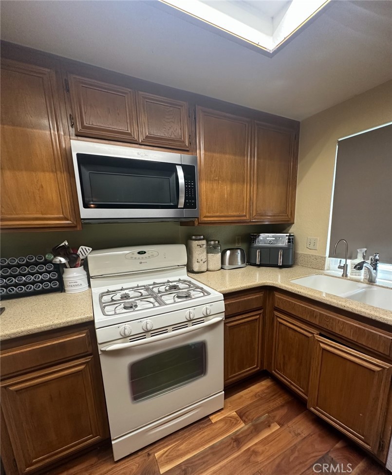 1510 Karon Street Redlands, CA 92374 - Photo 3 of 14 a kitchen with stainless steel appliances a stove a sink and a microwave