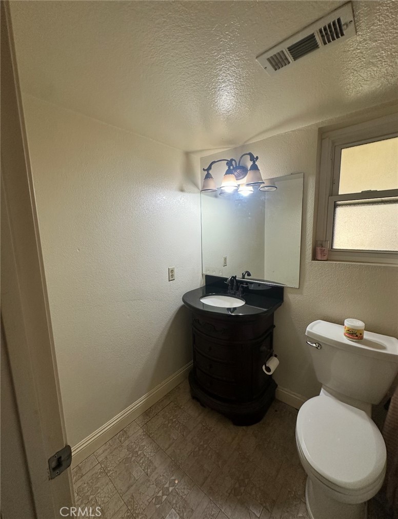 1510 Karon Street Redlands, CA 92374 - Photo 7 of 14 a bathroom with a toilet sink vanity and mirror