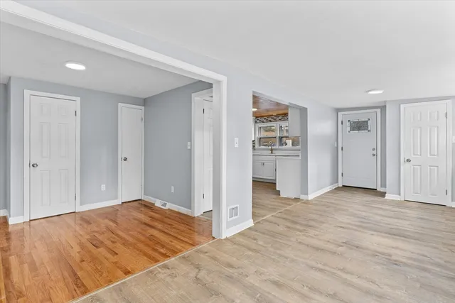 a view of a bedroom with wooden floor & closet area