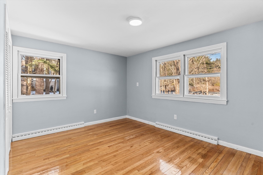 260 Great Road Stow, MA 01775 - Photo 18 of 32 a view of an empty room with wooden floor and a window