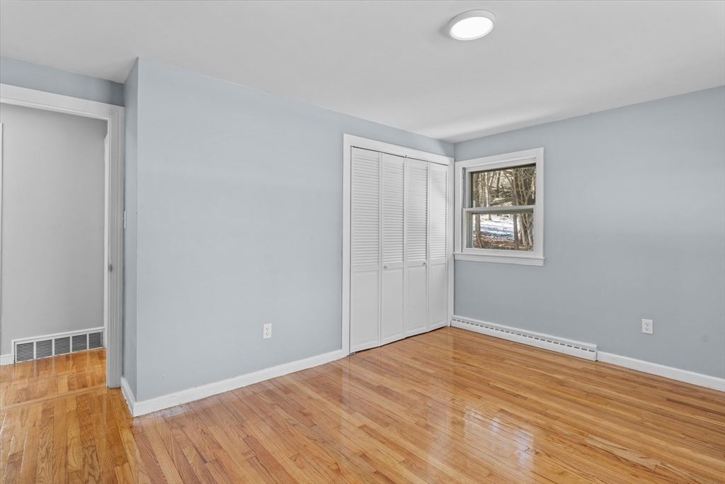 260 Great Road Stow, MA 01775 - Photo 19 of 32 a view of empty room with wooden floor and fan